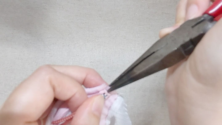 エレメントをペンチで押さえてスライダーを引っ張る